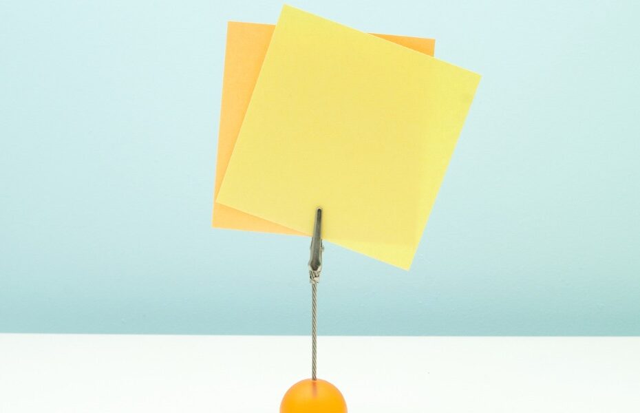 a note holder has a couple of sticky notes in it. Part of an article 10 ways to stay organized without a planner