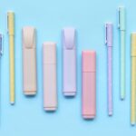 An array of pastel colored pens and markers are laid out. Part of an article: These Must See Bullet Journal Pens and Markers are Perfect for Beginners